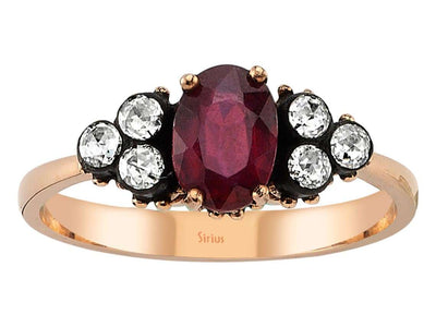 Elegant ring with oval ruby and six round diamonds in rose gold