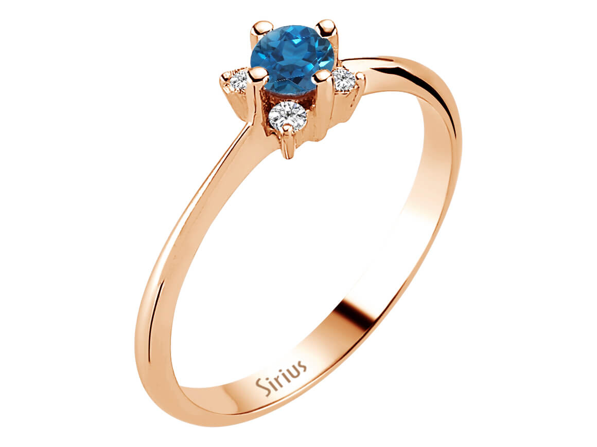 Rose gold ring with 4 diamonds and 1 round London blue topaz