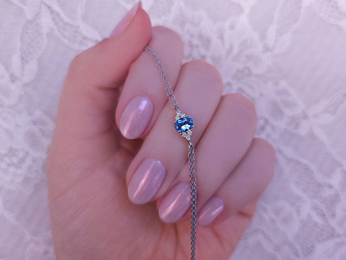 Fine bracelet with oval blue topaz and 6 lab-grown diamonds