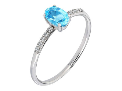 Fine white gold ring with oval blue topaz and pavé diamonds
