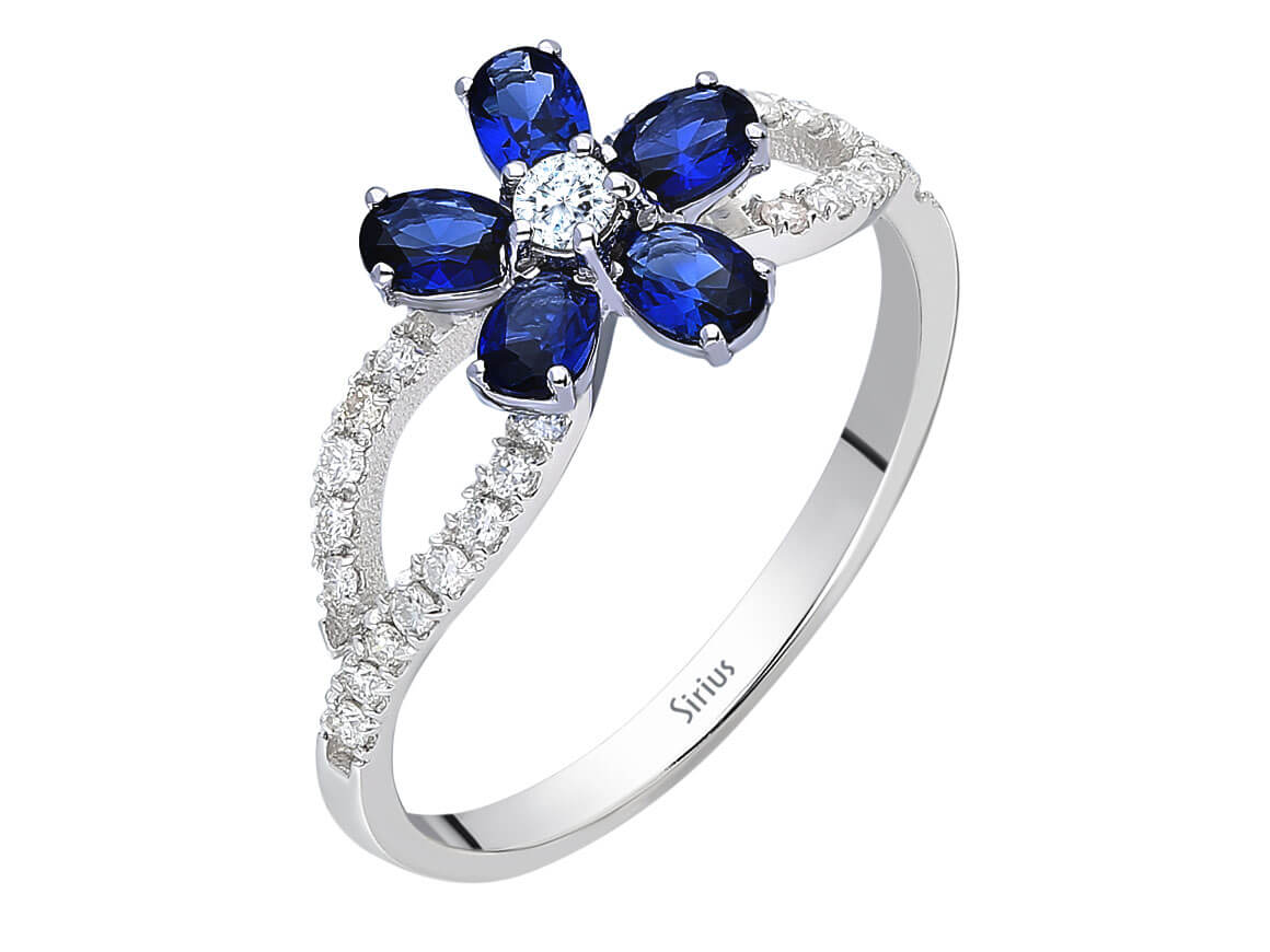 Eleganter Ring mit 1 rund geschliffenem Diamanten, 26 rund geschliffenen Diamanten und 5 ovalen Saphiren