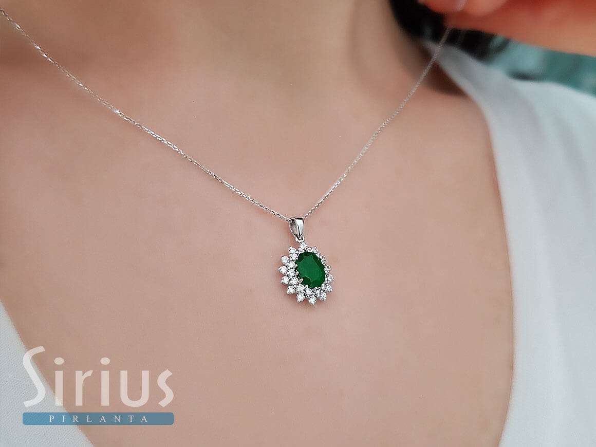 Anturage pendant with oval emerald and 28 round lab diamonds in 14K gold