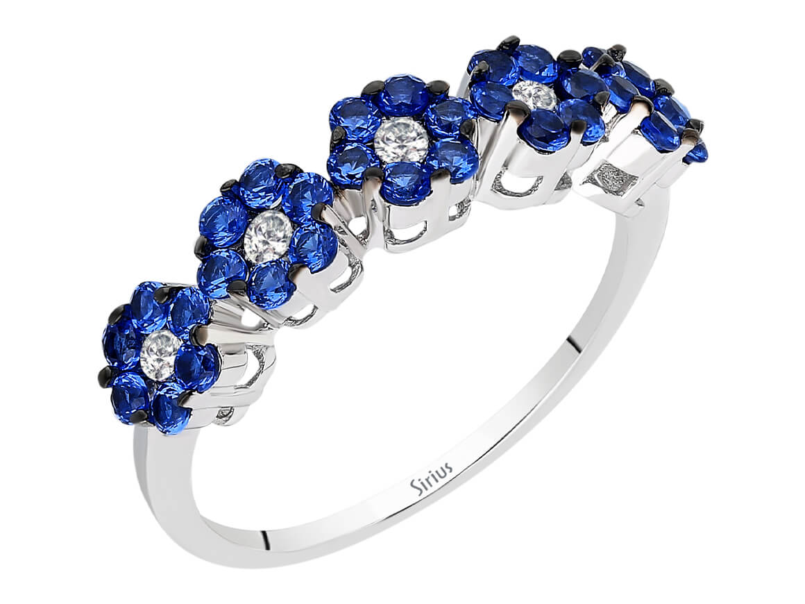Elegant ring with lab-grown diamonds and blue sapphires in flower design