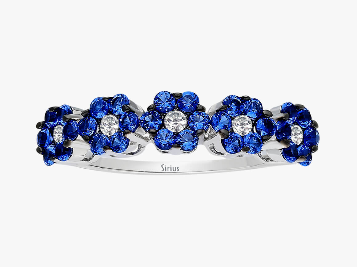 Elegant ring with lab-grown diamonds and blue sapphires in flower design