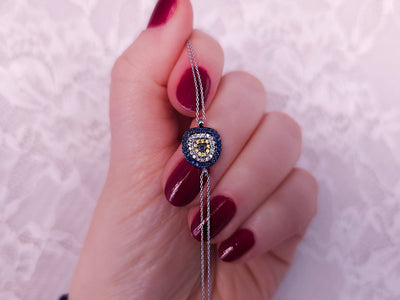 Nazar bead bracelet with sapphires and diamonds made of 14K white gold – 0.27 carat